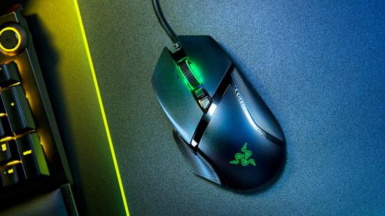 Razer Basilisk V2: a top down view of the mouse with surrounding RGB lights and a keyboard to its left