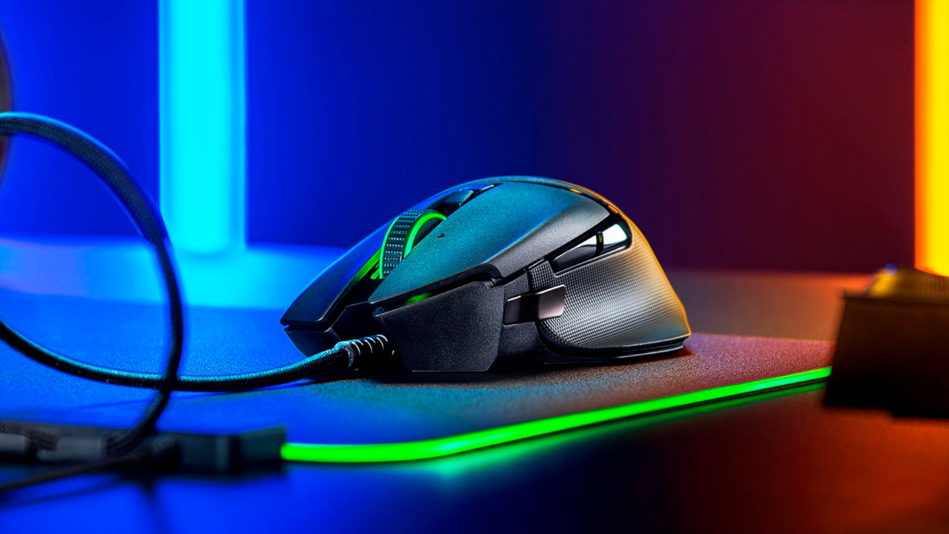 Razer Basilisk V2: a sid eon view of the mouse, on top of an RGB mouse mat