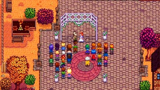 Two Stardew Valley players get married in the centre of a quaint town