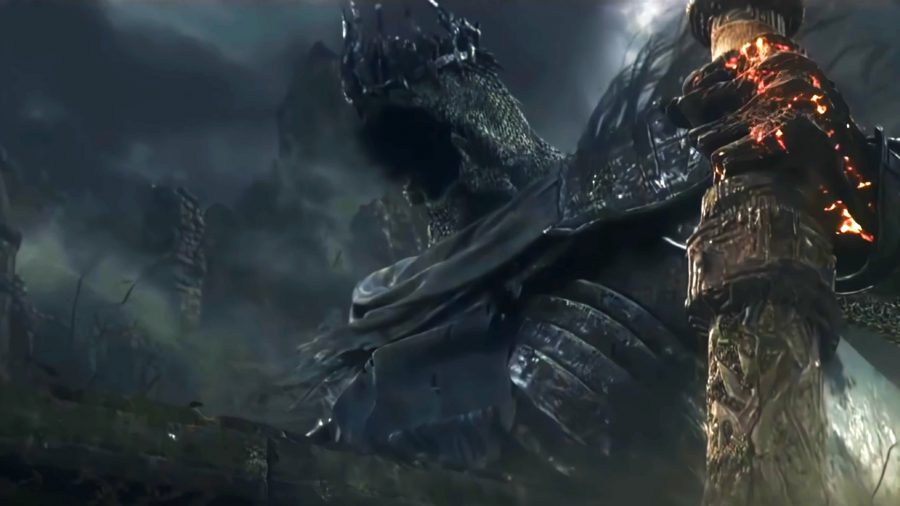 Elden Ring worst boss: Yhorm the Giant, a gimmick boss from Dark Souls 3, rises from his tomb; his face is shrouded beneath a chainmail coif and a crown of twisted metal, he clutches an enormous cleaver in his hand, and the sky behind him is dark with stormclouds