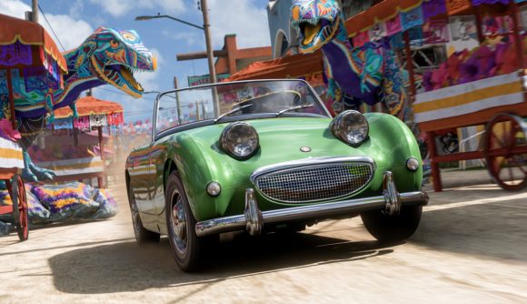 A classic green convertible races through festive streets, with two brightly painted T-rex sculptures posed in the background in Forza Horizon 5.