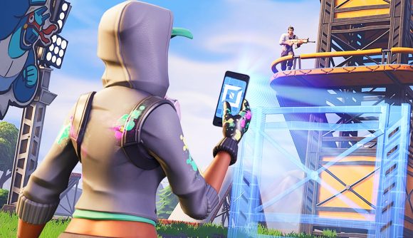 uTure Ali-A: a Fortnite player takes a picture of a structure with their phone