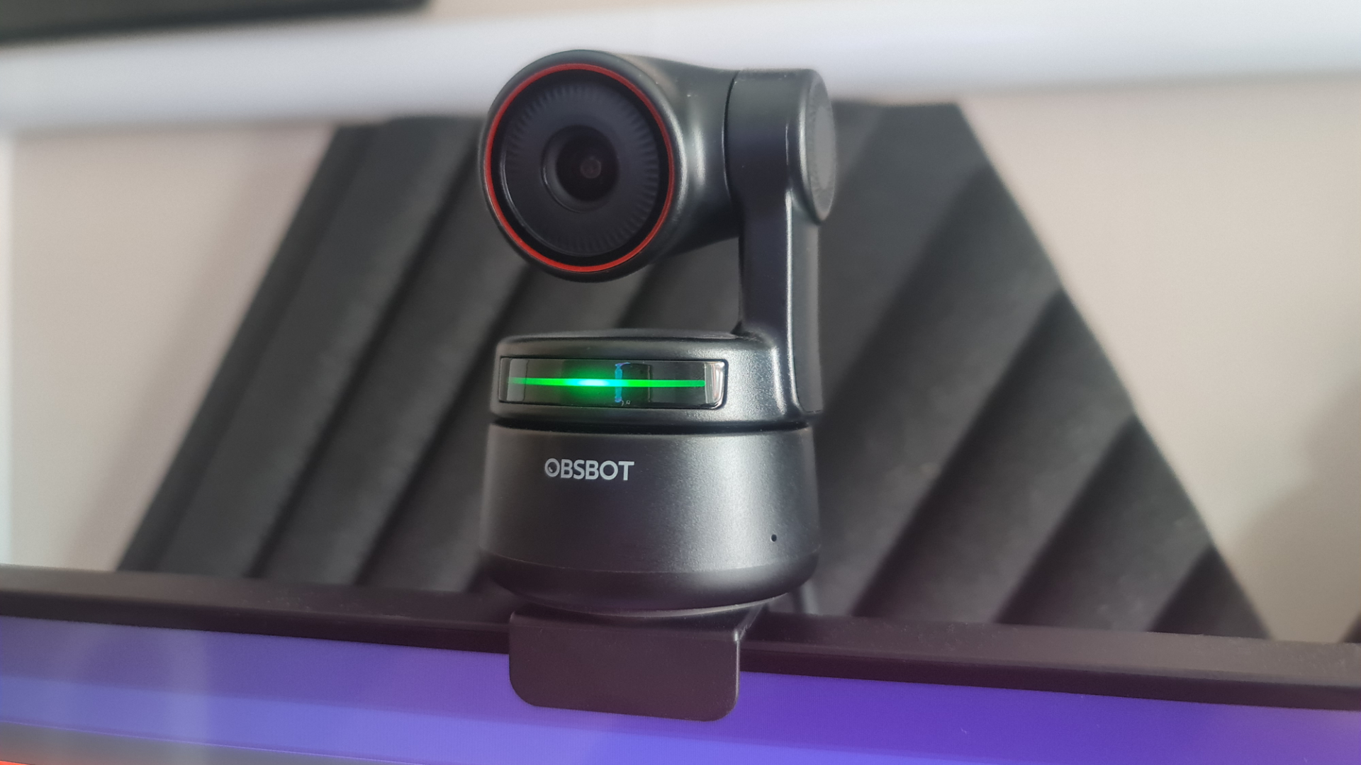 The best conference webcam, the OBSBot Tiny 4K, sits above a gaming monitor