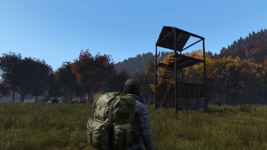 Dayz base building: A survivor stands in front of a small custom watchtower