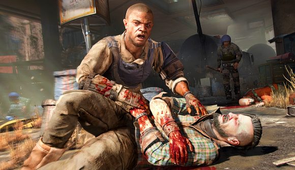 Dying Light 2 DLC delay: a man aids a wounded man lying on the ground