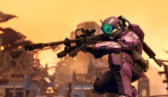 A Spartan in purple armour steadies a sniper rifle against the yellow sky of a sunset in Halo Infinite Season 2 - Lone Wolves