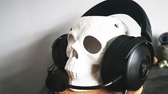 The Razer Kraken V3 Hypersense is the most immersive gaming headset, seen here wrapped around a fake skull