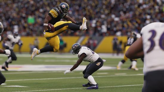 Madden NFL 23 PC edition: A Pittsburgh Steelers ball carrier leaps over a Baltimore Ravens defender in a crouch in Madden NFL 23.