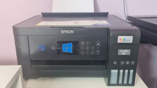An Epson printer with a broken Windows 10 logo on the LCD screen