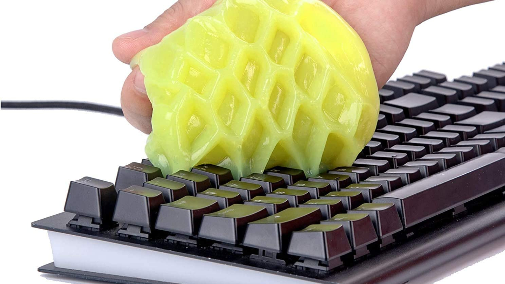 How to clean the keyboard: Generic keyboard with someone using putty gel