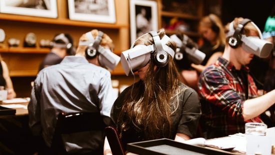 A group of people wearing Oculus Quest 2 headsets in a restaurant