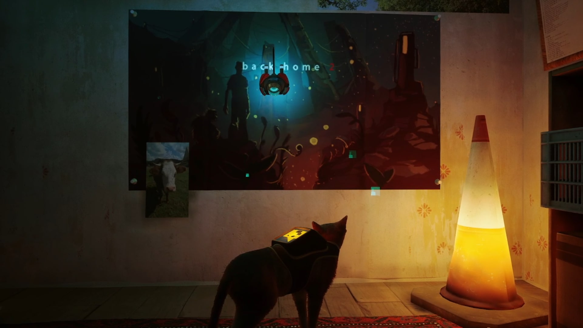 Stray memories guide: The orange tabby standing in front of the Back Home 2 poster which depicts a human standing in front of a strange alien structure