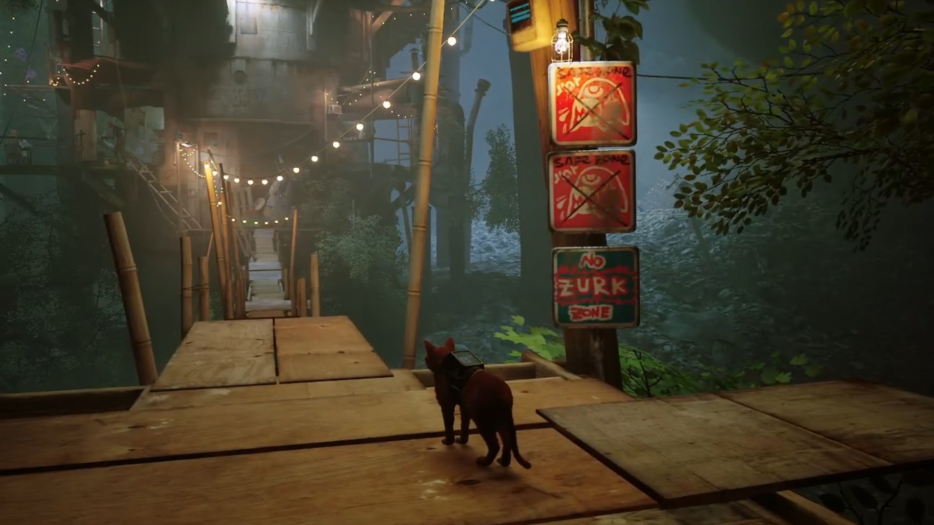Stray memories guide: The orange tabby standing by the bridge leading to Antvillage that's strung up with fairy lights and bears a series of colourful notices declaring it a No Zurk Zone