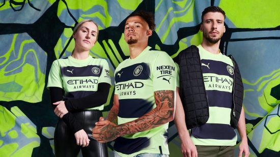 Three people stand dressed in Manchester City Third kit.