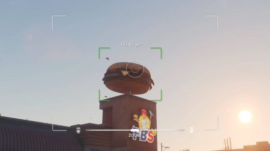 Saints Row guide: the viewpoint is through a camera, analysing if it's in focus to take a picture of the giant hamburger resting on top of a burger joint called FB's.