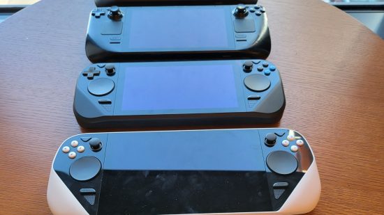 Steam Deck prototypes show the evolution of Valve's handheld gaming PC: a picture of tree Steam Deck prototypes on a table