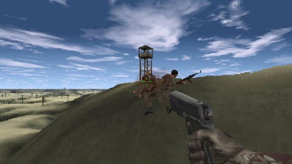 A blurry screenshot of a large pistol being used to shoot two pixelated soldiers in the back on a desert hillside.