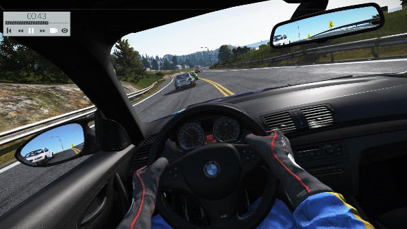Cockpit view of a stock BMW chasing its peers down a coastal highway.